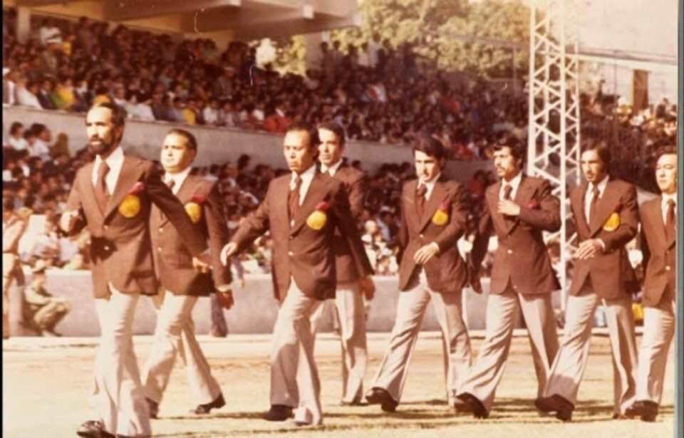 Atta Arghandiwal marching with Kabul football team directors at Ghazi Stadium.
