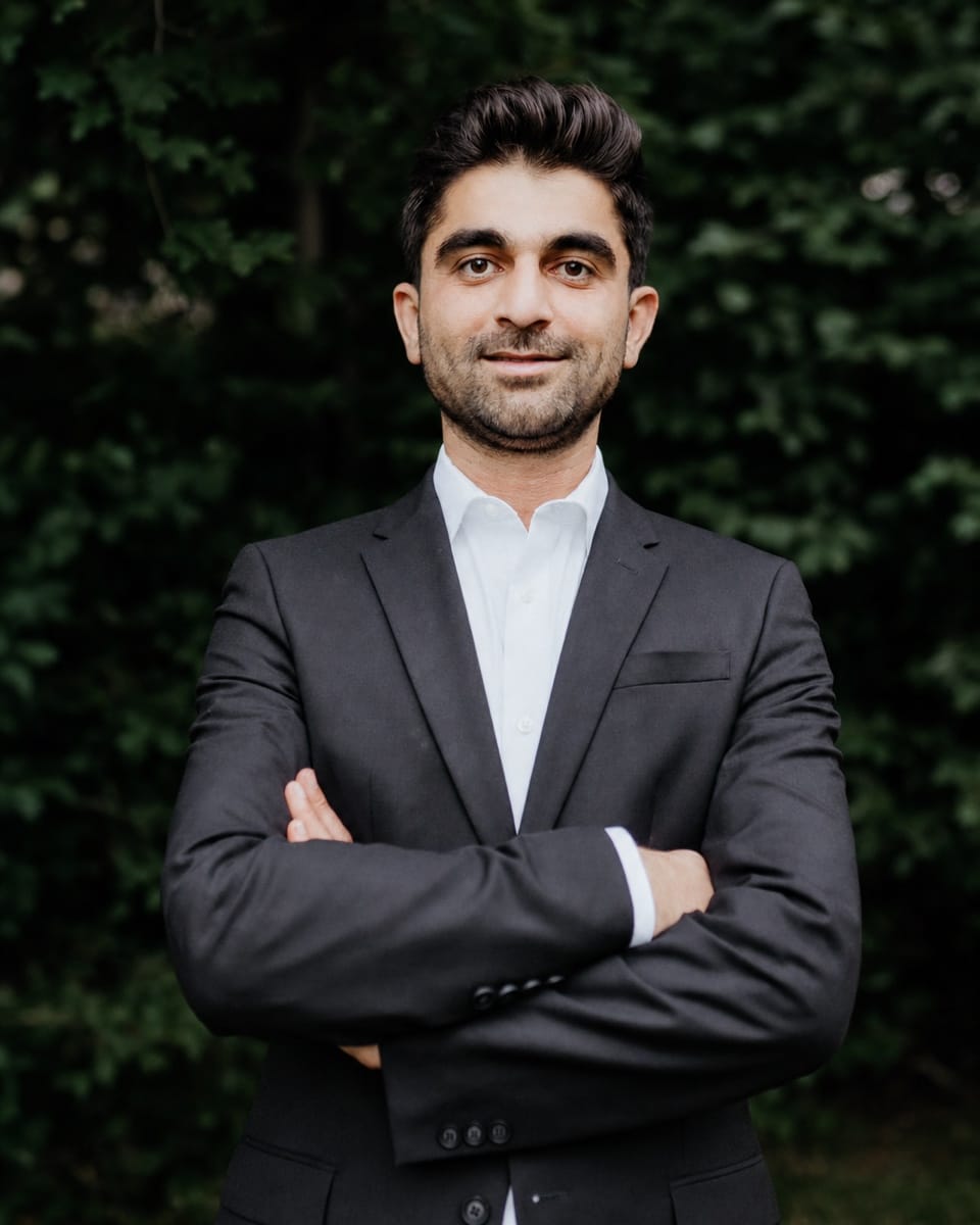 Sohrab Rasouli in a formal editorial portrait.